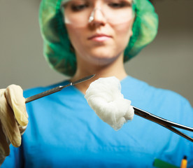 Woman surgeons holding medical instruments in hands