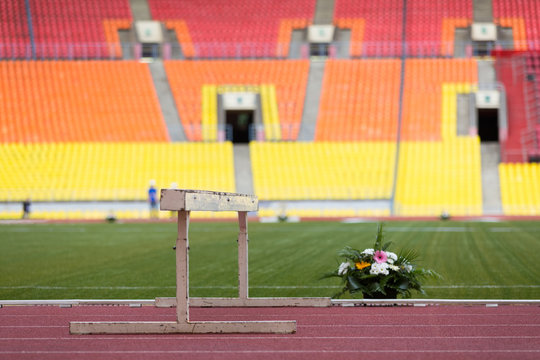 Barrier and beautiful flowers on the track stadium.