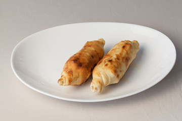 Appetizing baked with cheese on a plate.