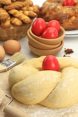 Fototapeta na wymiar Easter sweet bread dough with red eggs