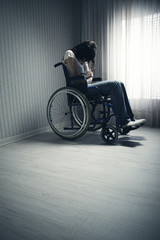 Crying woman sitting in wheelchair