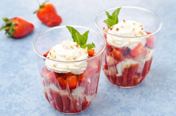 dessert with cookies, berry puree, strawberries, whipped cream