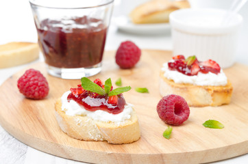 Toasted baguette with cream cheese, raspberry jam