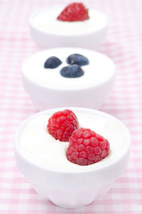 yogurt with different fresh berries in bowls