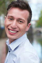 Portrait of an attractive young man smiling outdoors