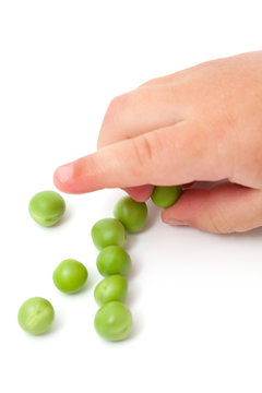 fresh peas and child's hand