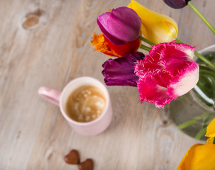 Obraz na płótnie Canvas Colorful tulips and a cup of fresh coffee