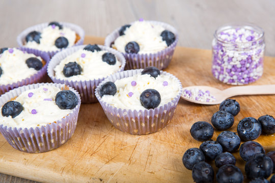 Delicious cupcake with blueberries, cream and fresh berries