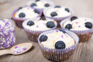 Delicious cupcake with blueberries, cream and fresh berries