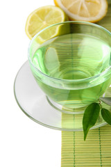 Transparent cup of green tea with lemon