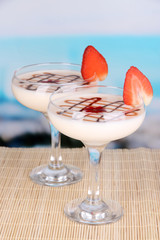 Fruit smoothies on table on blue background