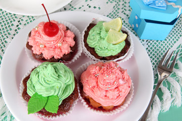 Delicious beautiful  cupcakes on dining table close-up