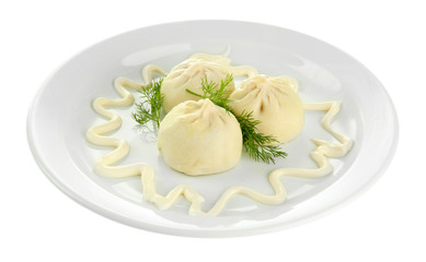 Tasty khinkali on plate, isolated on white