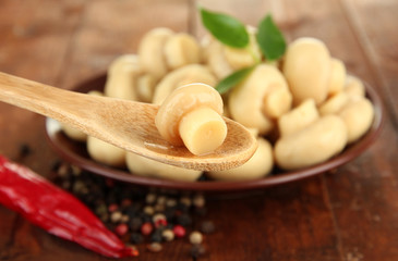 Mushrooms on plate, on wooden background