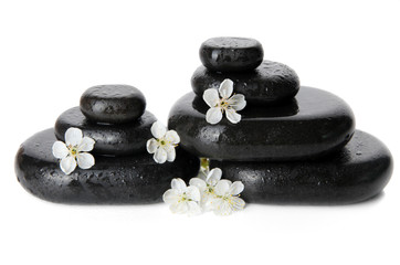 Spa stones and white flowers isolated on white