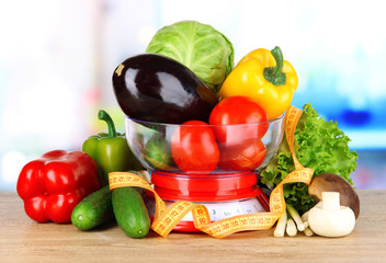 Fresh vegetables in scales on table in kitchen