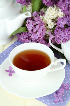 Composition with beautiful lilac flowers, tea service