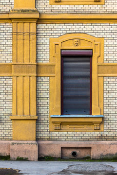 wall of an old building with a window and a column
