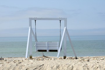 Wooden swinging seat on the beach