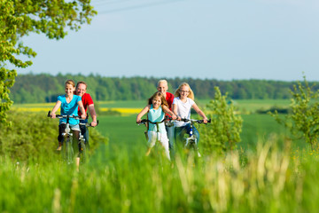 Family cycling outdoors in summer