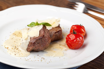 Roasted meat under white sauce