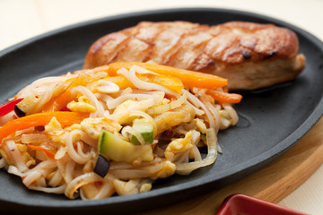 Grilled chicken breasts and noodles
