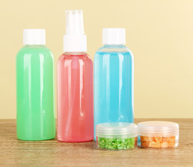 Hotel amenities kit on table on beige background