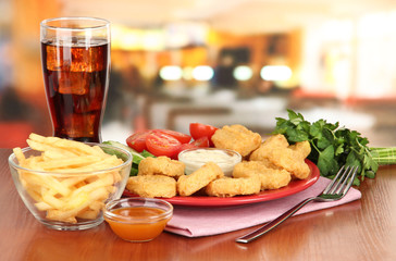 Fried chicken nuggets with vegetables,cola,french fries and