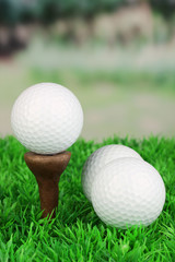Golf balls on grass outdoor close up