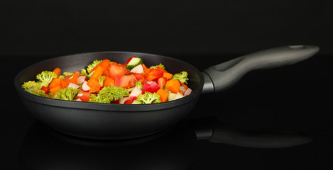 Vegetable ragout in pan, isolated on black