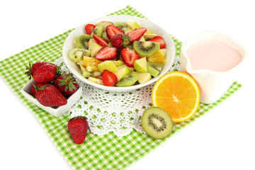 Useful fruit salad of fresh fruits and berries in bowl isolated