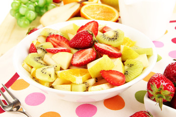 Useful fruit salad of fresh fruits and berries in bowl