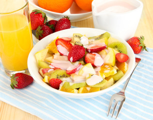 Useful fruit salad of fresh fruits and berries in bowl