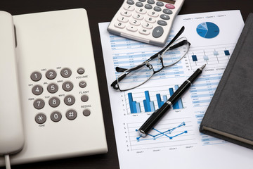 business report with telephone on a table