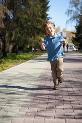 Fototapeta premium Boy running along road in park