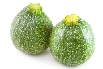 two zucchini on white background
