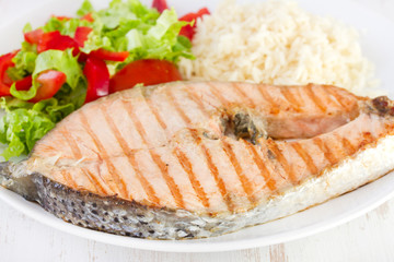 grilled salmon with rice and salad on dish