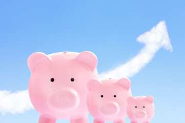 pink piggy banks with sky and cloud arrow