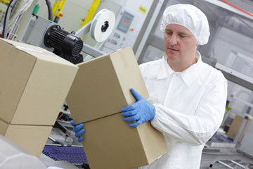 manual worker at production line dealing with boxes