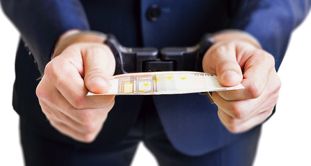 Man in handcuffs is holding money