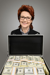 Businesswoman showing a briefcase full of money - isolated