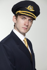 Young man in the form of a passenger plane pilot