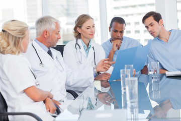 Medical team examining a file