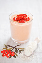 Smoothie with goji berries and oat bran powder, selective focus