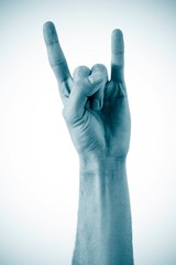 A man's hand giving the Rock and Roll sign isolated on a white b