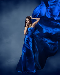Woman in blue dress  with flying silk fabric