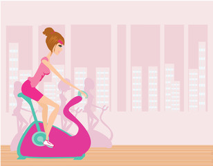Indoor Cycling - Girls cycling at Gym