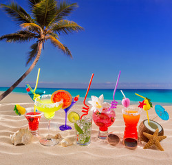 Colorful tropical cocktails at beach on white sand