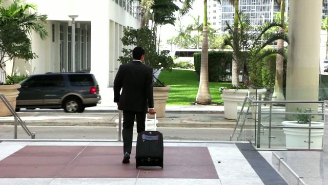 Young city businessman with travel luggage
