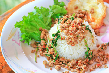 Thai spicy food; Fried pork with sweet basil and fried egg